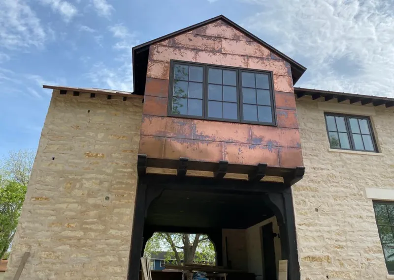 Copper metal panel facade on a stone building for Roof Repair in Zuni Pueblo