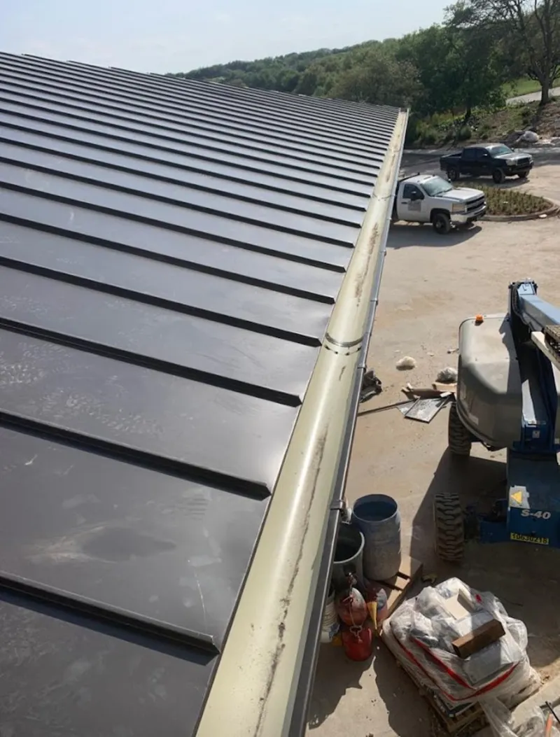 Standing seam panel and gutter detail on a metal roofing jobsite in Zuni Pueblo